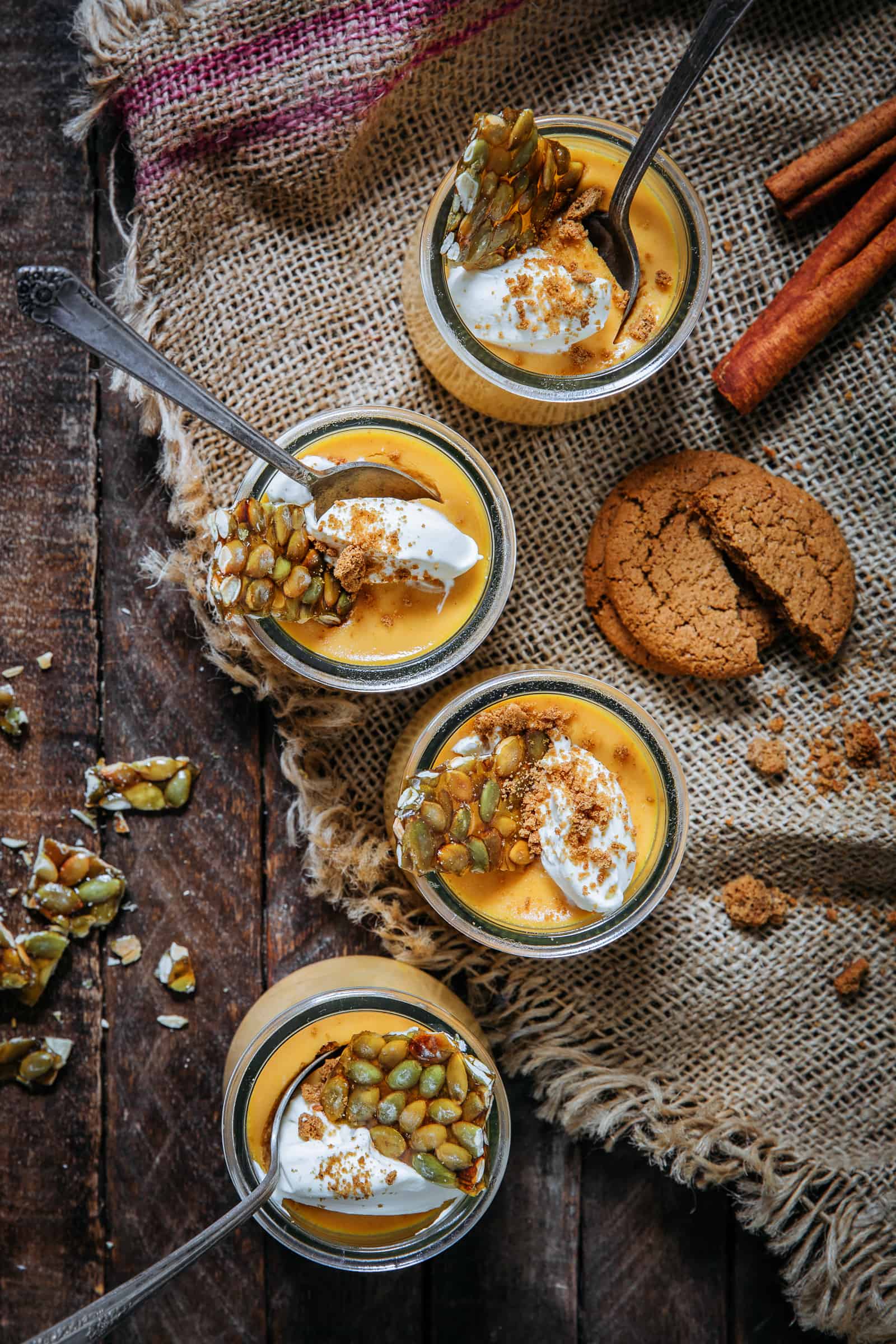 Jars of pumpkin custard topped with pumpkin seed brittle