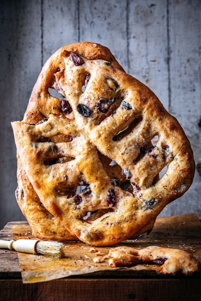 Fougasse bread stacked on a wooden crate